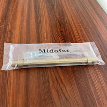 Load image into Gallery viewer, Midofar champagne bronze cabinet handle in packaging on wooden table.