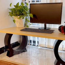 Load image into Gallery viewer, Matte black metal chair legs supporting a wooden desk with a monitor and potted plant, from Triumph Hardware.