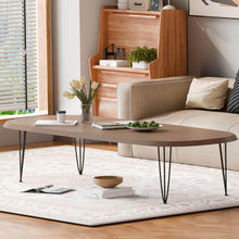 Load image into Gallery viewer, Modern wood table with 28" matte black 3-rod hairpin legs, set in cozy living room with sofa and bookshelf.
