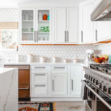 Carica l'immagine nel visualizzatore di Gallery, Modern kitchen with white cabinets featuring satin nickel T-bar cabinet pulls and a sleek stainless steel oven.