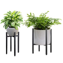 Load image into Gallery viewer, Adjustable metal plant stand in matte black holding potted plants, tool-free assembly, reversible design, suitable for indoor and outdoor use.