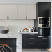 Load image into Gallery viewer, Modern kitchen with black and white cabinets featuring brushed satin nickel square drawer handles by Triumph Hardware.