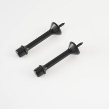 Load image into Gallery viewer, Two matte black rigid baseboard door stops with soft rubber tips and anti-fading finish.
