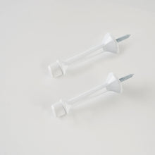 Load image into Gallery viewer, Pair of white anti-fading zinc alloy door stops designed for baseboard mounting.
