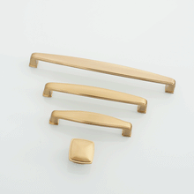 Load image into Gallery viewer, Brushed champagne bronze handles mounted on bathroom cabinets.
