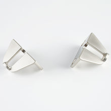 Load image into Gallery viewer, Front view of two Mist Silver brackets from the Internal Handle Adapter Set securing a black handle.
